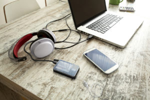 Photo Retouching-Edited by Digital Imaging Group-Smartphone, Headphones and Laptop on a wooden Desktop.